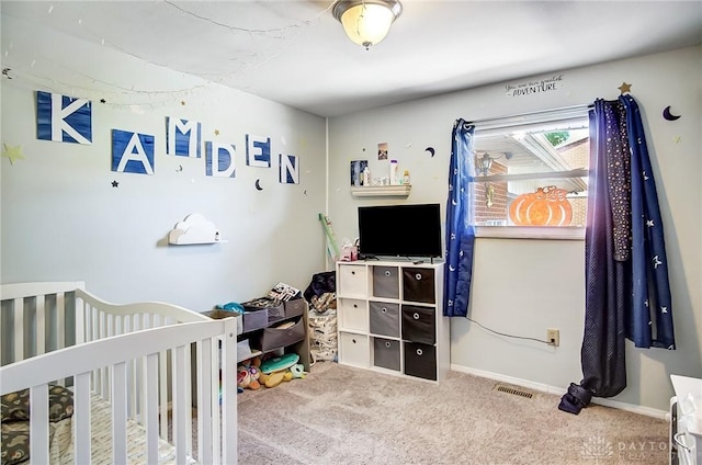 carpeted bedroom featuring a nursery area, visible vents, and baseboards