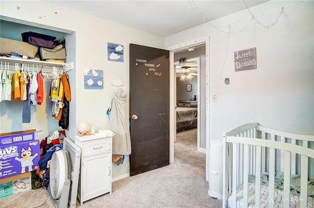 bedroom featuring baseboards, a closet, and light colored carpet