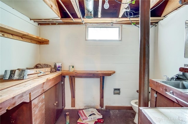 interior space with concrete floors, light countertops, and a sink