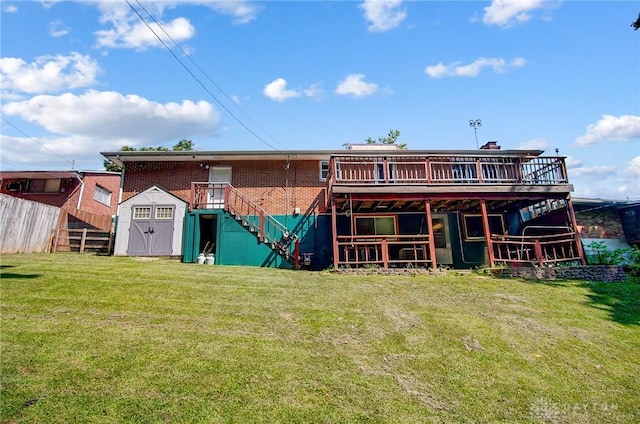 back of house with a lawn, a deck, and a storage unit