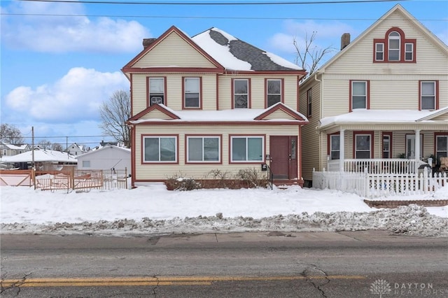 view of front of house with covered porch and fence