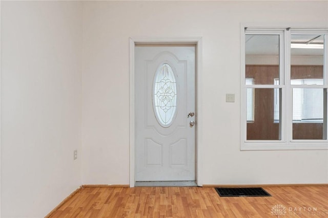 entrance foyer featuring light wood-type flooring, visible vents, and baseboards