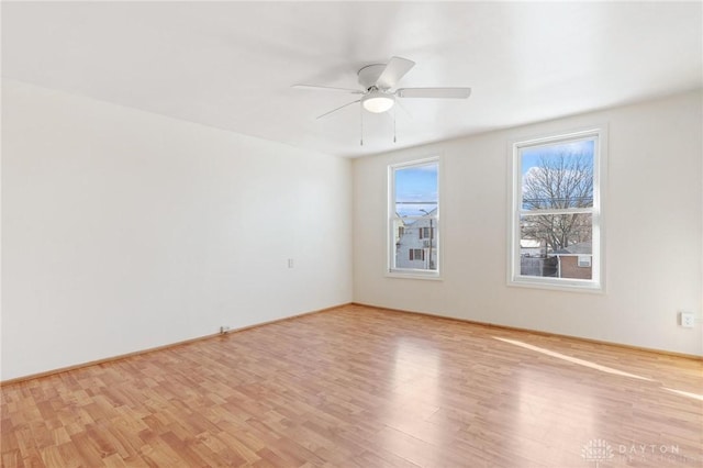 spare room with ceiling fan and light hardwood / wood-style flooring