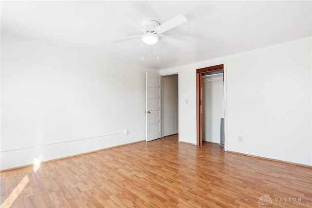 unfurnished bedroom with light hardwood / wood-style flooring, a closet, and ceiling fan