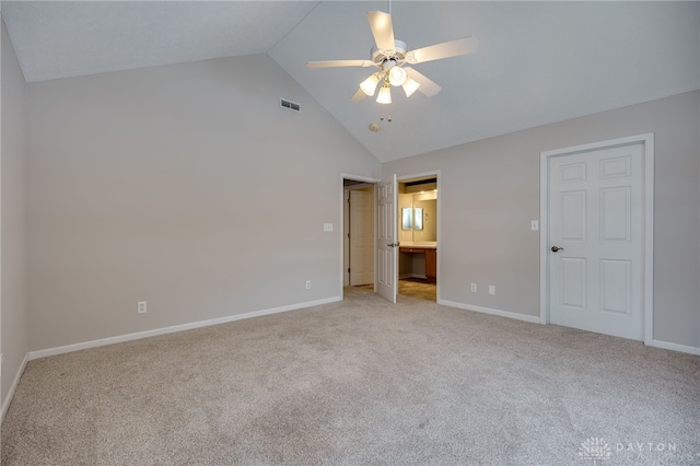 unfurnished bedroom with ensuite bathroom, high vaulted ceiling, light carpet, and ceiling fan