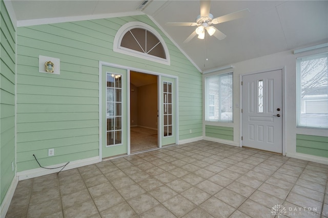 unfurnished sunroom with vaulted ceiling, ceiling fan, and french doors