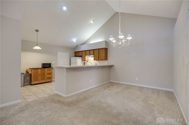 kitchen with a chandelier, white refrigerator, hanging light fixtures, kitchen peninsula, and light carpet