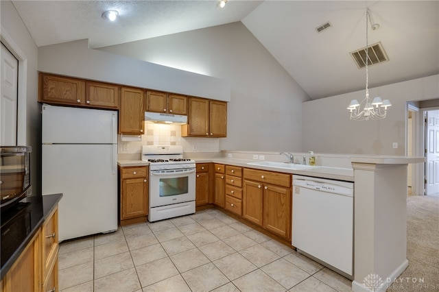 kitchen featuring high vaulted ceiling, sink, hanging light fixtures, kitchen peninsula, and white appliances