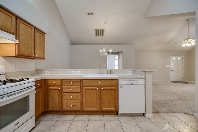 kitchen with sink, white appliances, kitchen peninsula, light colored carpet, and decorative backsplash