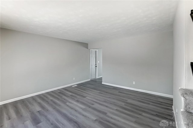 spare room featuring dark hardwood / wood-style floors