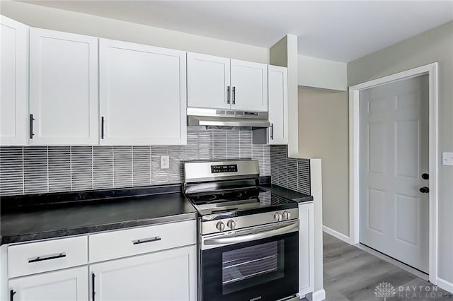 kitchen featuring tasteful backsplash, white cabinetry, stainless steel range with electric cooktop, and light wood-type flooring