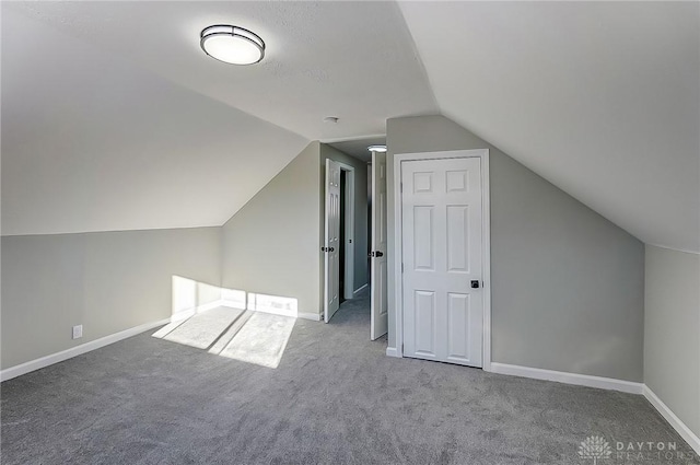 bonus room with carpet floors and vaulted ceiling