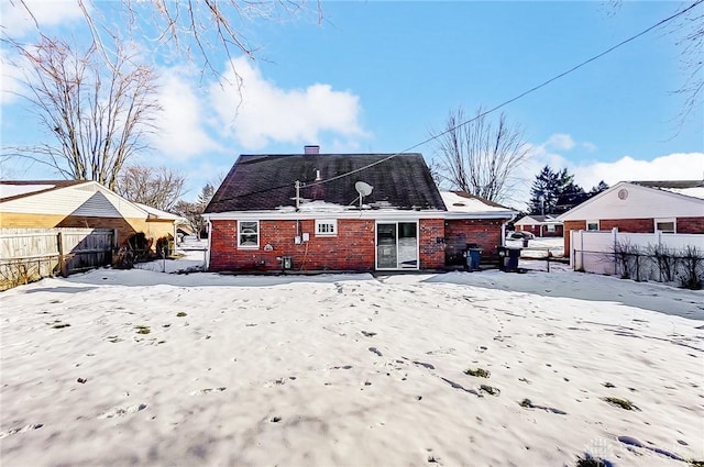 view of snow covered rear of property