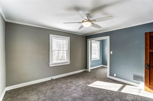 spare room featuring visible vents, plenty of natural light, and baseboards