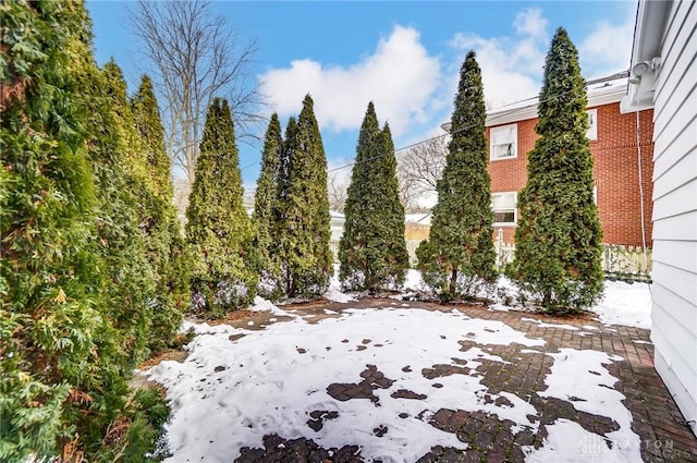 yard covered in snow with a patio area