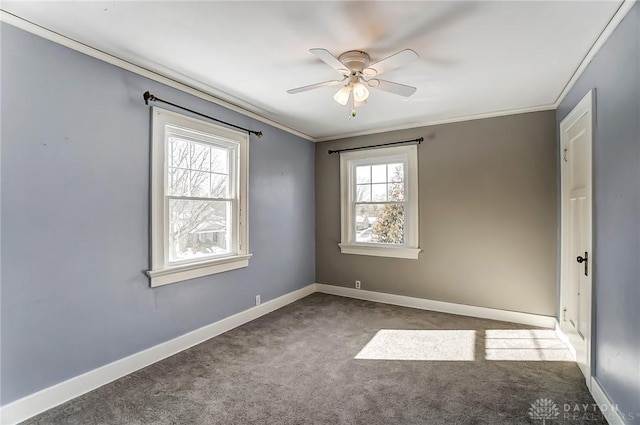 empty room with baseboards, carpet floors, a ceiling fan, and crown molding