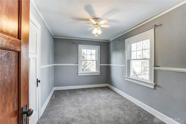 spare room featuring ornamental molding, carpet flooring, ceiling fan, and baseboards