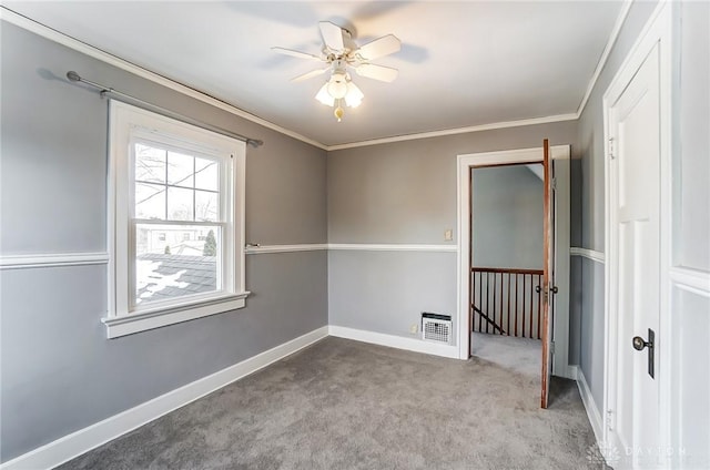 spare room with light carpet, baseboards, visible vents, a ceiling fan, and crown molding