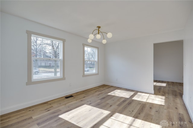 545 E Whipp Rd, Dayton, OH 45459 - unfurnished room featuring wood finished floors, a chandelier, and baseboards
