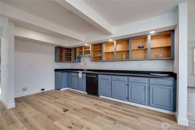 kitchen featuring dark countertops, light wood-style flooring, open shelves, and dishwasher