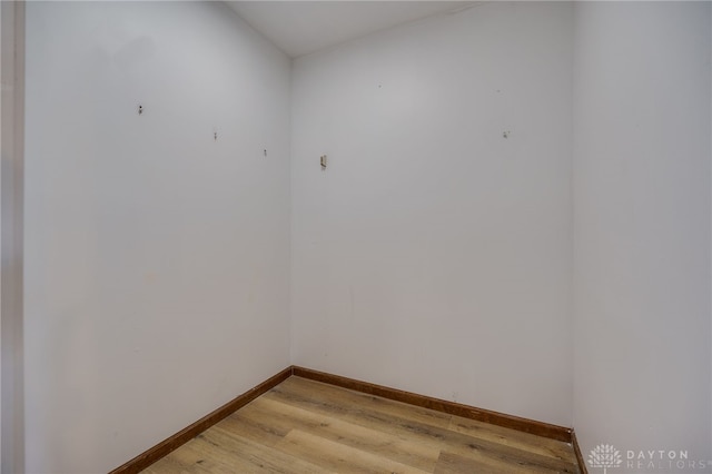 unfurnished room with light wood finished floors and baseboards