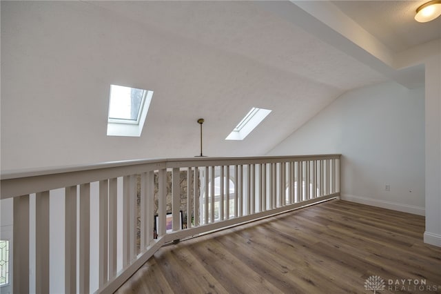 bonus room featuring lofted ceiling, wood finished floors, and baseboards