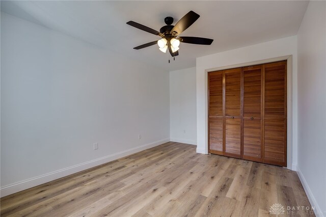 545 E Whipp Rd, Dayton, OH 45459 - unfurnished bedroom featuring baseboards, light wood finished floors, a closet, and ceiling fan