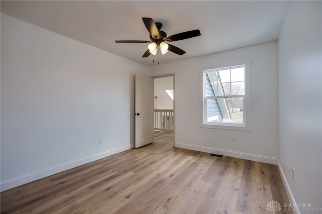 unfurnished room with baseboards, visible vents, and light wood finished floors