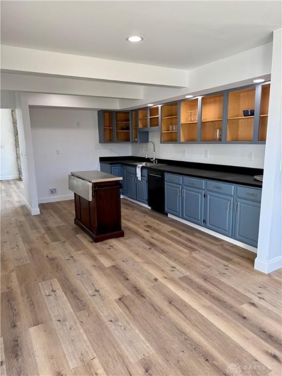 545 E Whipp Rd, Dayton, OH 45459 - kitchen featuring open shelves, black dishwasher, dark countertops, a center island, and blue cabinets