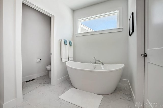 bathroom featuring a bathing tub and toilet