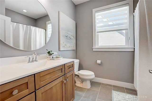 bathroom featuring tile patterned floors, plenty of natural light, toilet, and vanity