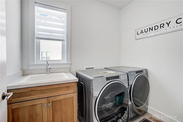 laundry room featuring cabinets, washing machine and clothes dryer, tile patterned flooring, and sink