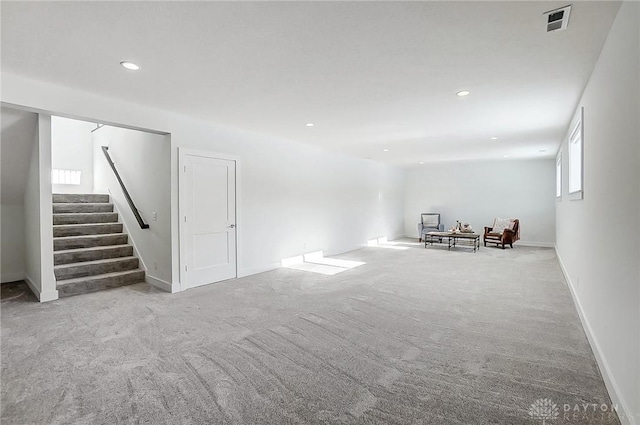 unfurnished living room featuring light carpet