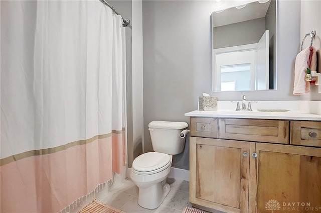 bathroom with tile patterned flooring, vanity, and toilet