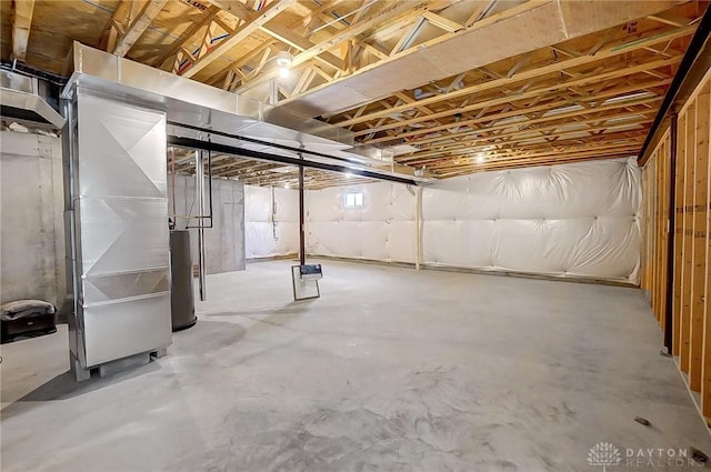 basement featuring heating unit and water heater