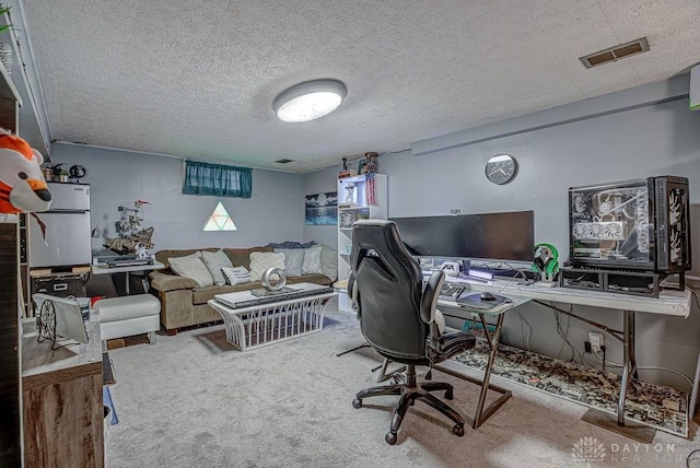 carpeted office space with a textured ceiling