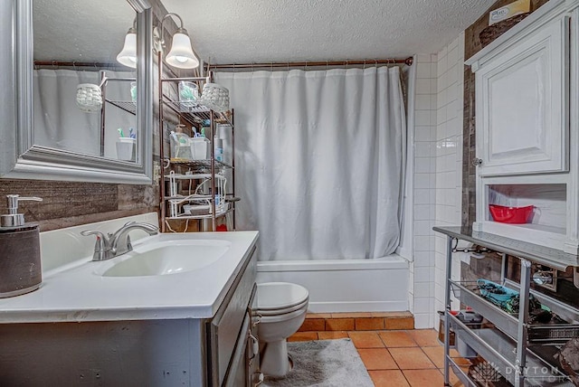 full bathroom featuring shower / tub combo with curtain, tile patterned floors, toilet, a textured ceiling, and vanity