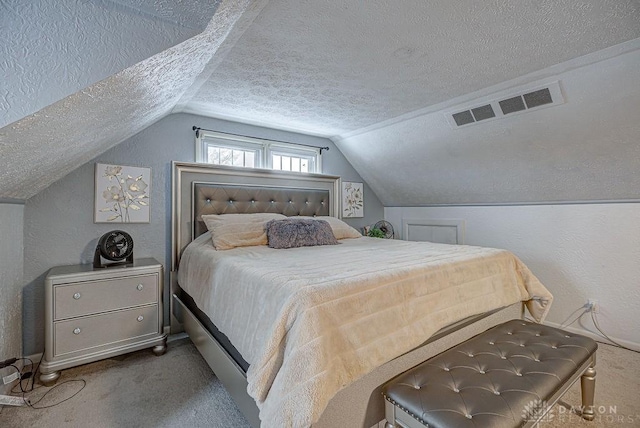 carpeted bedroom featuring vaulted ceiling and a textured ceiling