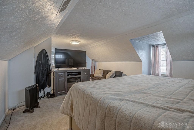 carpeted bedroom featuring lofted ceiling, radiator, and a textured ceiling