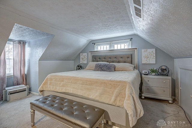 bedroom with vaulted ceiling, carpet, a textured ceiling, and an AC wall unit