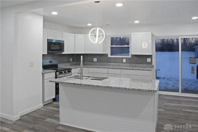 kitchen with sink, pendant lighting, white cabinets, and stainless steel range with electric stovetop