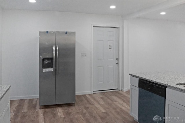 kitchen with light stone counters, stainless steel appliances, and dark hardwood / wood-style floors