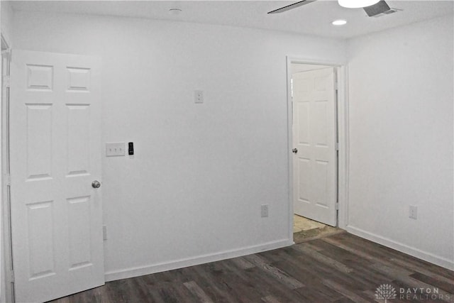 unfurnished room featuring dark hardwood / wood-style floors and ceiling fan