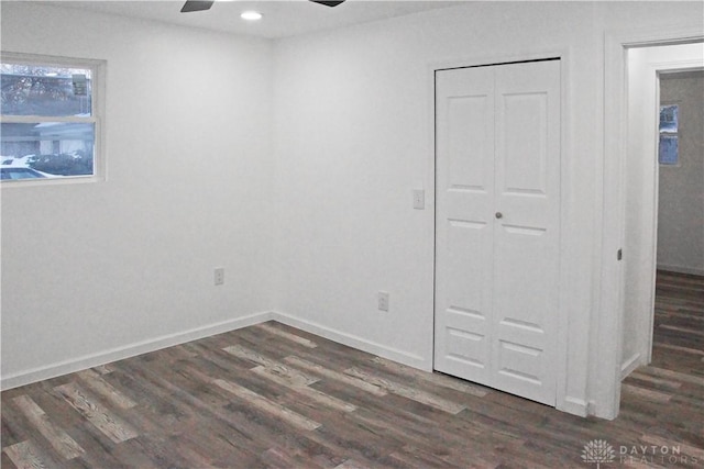 spare room featuring ceiling fan and dark hardwood / wood-style flooring