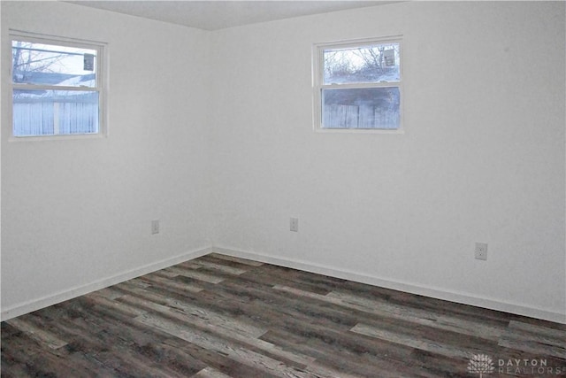 unfurnished room with dark wood-type flooring and a healthy amount of sunlight