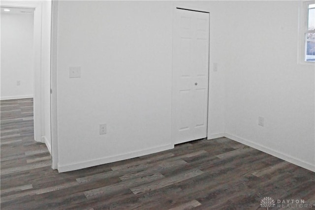 unfurnished room with dark hardwood / wood-style floors