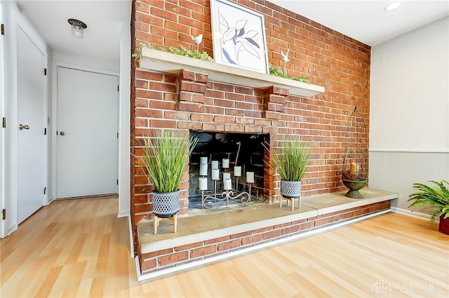 room details with a brick fireplace and hardwood / wood-style flooring