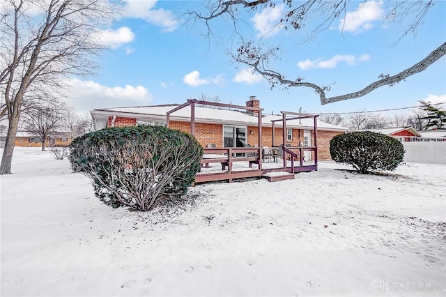 snow covered property featuring a deck