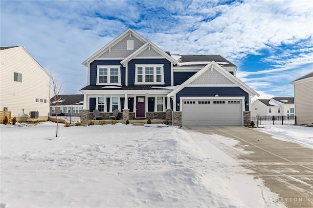 craftsman house with a garage and central AC