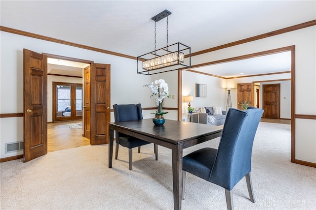 dining room featuring light parquet flooring and ornamental molding